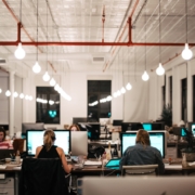 Office Setting with overhead lights and people sitting at computers