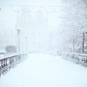 A photo of a snow covered walkway in a city.
