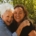 A stock photo of a middle aged white woman and an older white woman embracing outside.