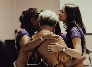 A group of South Asian women of different ages embracing.