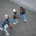 Four people wearing backpacks and walking, taken from above.