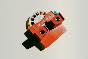 A photo of an old Viewmaster toy with a reel of photos inside it.