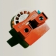 A photo of an old Viewmaster toy with a reel of photos inside it.