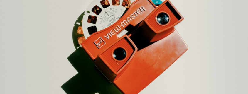 A photo of an old Viewmaster toy with a reel of photos inside it.