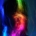 A silhouette of a person with long hair with colorful bands of light over their face.