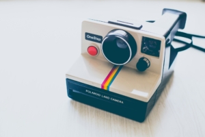 A polaroid camera on a white background.