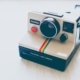 A polaroid camera on a white background.