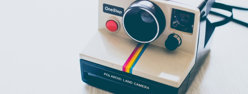 A polaroid camera on a white background.