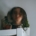 A blurry face in a mirror on top of a cabinet.