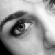A close up of a woman's face in black and white.