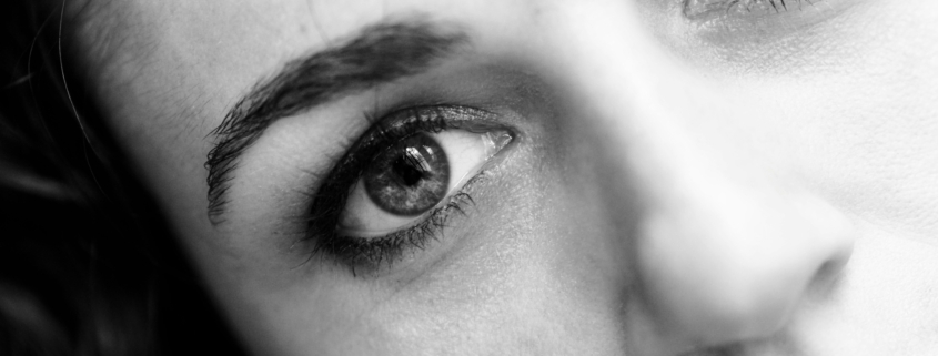 A close up of a woman's face in black and white.