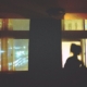 A silhouette of a woman sitting in front of a window.