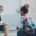A white therapist sitting across from a Black patient in a therapy office.