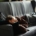 Woman in sweats laying on a gray couch